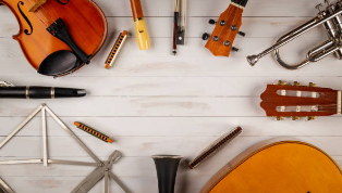 Selection of musical instruments including guitars, keyboards, and drums in a music studio.